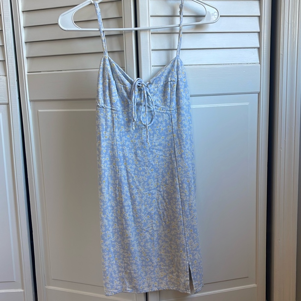 Floral dress with stretchy material in back, adjustable straps, and a small slit